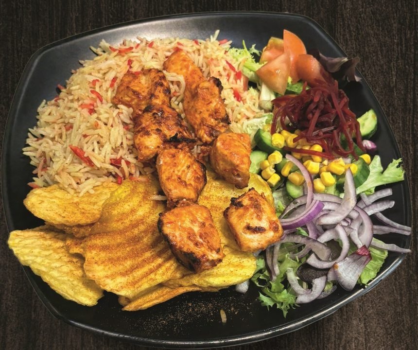 Plato de brochetas de pollo con arroz, patatas y ensalada